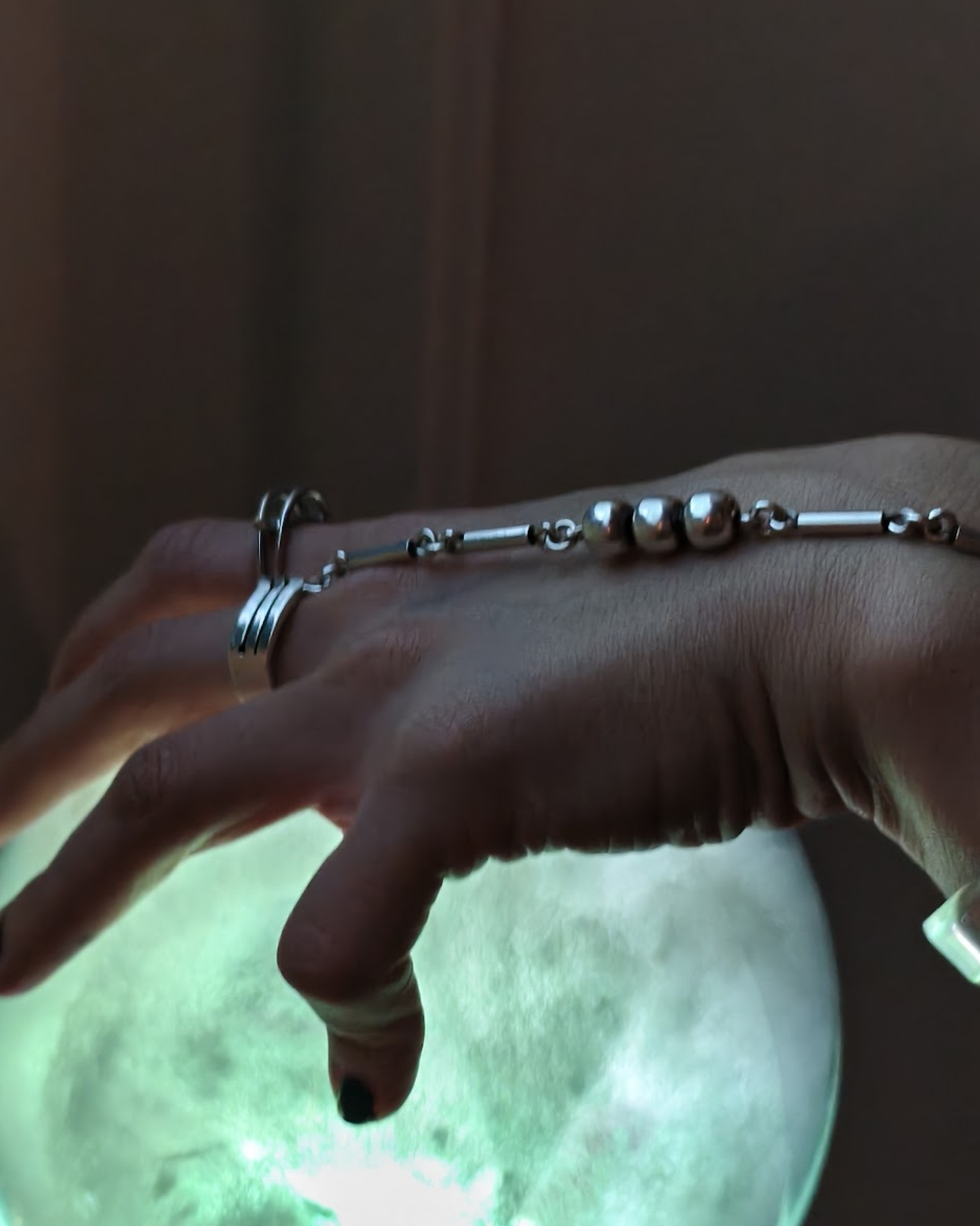 Hands hovering over Vibe Altar crystal ball activating proximity sensor